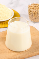 Fresh Soybean Milk with Soybeans and Powder - Healthy Plant-Based Dairy Replacement Drink on Wooden Board