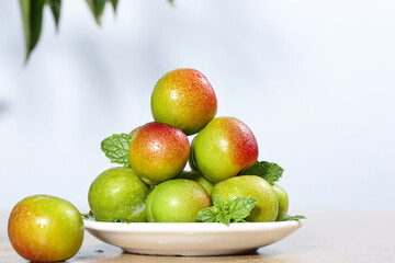 Fresh Red Green Plums in White Bowl with Mint Leaves Healthy Organic Stone Fruit