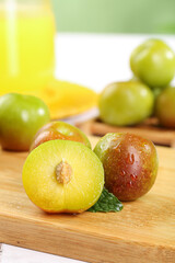 Fresh Cut Plums with Yellow Pulp on Wooden Cutting Board - Healthy Fruit Food Photography