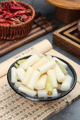 Fresh lotus root slices in bowl with spicy red chilies - traditional Asian vegetable ingredients for cooking