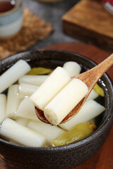 Pickled Lotus Root with Spicy Chili Sauce - Traditional Asian Fermented Vegetable Dish in Ceramic Bowl
