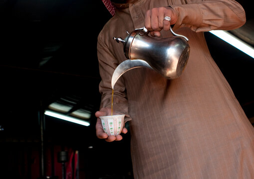 Portrait of a saudi man serving coffee, Al-Jawf Province, Sakaka, Saudi Arabia