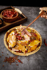 Chongqing Spicy Chicken with Hot Peppers and Sichuan Peppercorns in Traditional Bamboo Basket