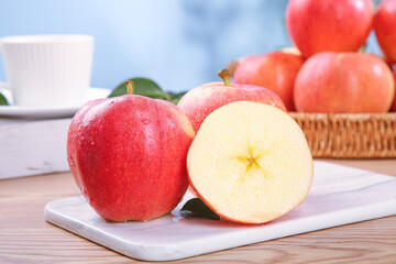 Fresh Red Fuji Apples on Kitchen Counter with Sliced Apple Half Showing Crisp White Flesh