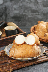 Fresh Wild Asparagus Roots on Rustic Wooden Tray with Traditional Ceramic Dishware