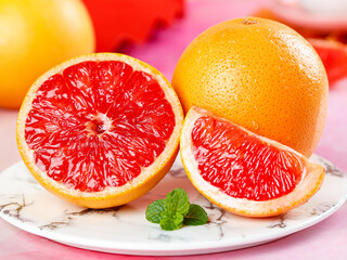Fresh Red Grapefruit Slices with Mint on Marble Plate - Healthy Citrus Fruit Close-Up