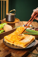 Handmade shredded potato pancakes with chopsticks - traditional breakfast dish on wooden table