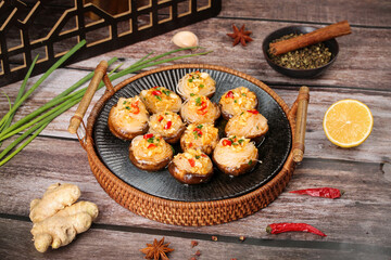 Teppanyaki Stuffed Shiitake Mushrooms with Garlic and Asian Spices on Rustic Wooden Table