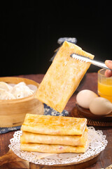 Handmade Golden Potato Pancakes with Tongs on Rustic Wooden Table Kitchen Setting