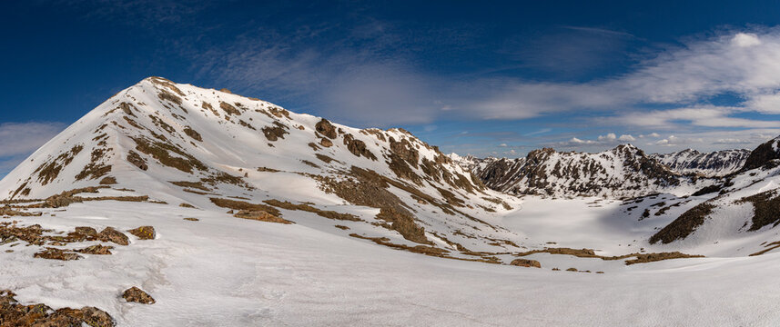 This spring Colorado mountain panorama features mostly snow covered Thirteener (13er) Geissler Mountain East  and frozen snow covered Lost Man Lake.