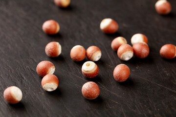 Fresh Hazelnuts with Red Shells on Dark Wood Background - Healthy Nuts and Traditional Foods