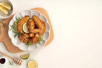 Honey Lemon Glazed Chicken Wings with Sesame and Lime.