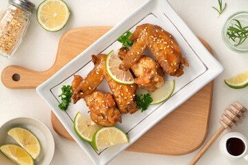 Honey Lemon Glazed Chicken Wings with Sesame and Lime.