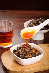 Spicy Chili Oil Drizzled Over Cooked Snails Traditional Asian Seafood Dish on Wooden Board