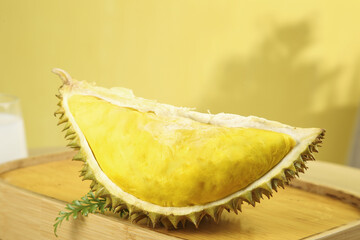 Fresh Golden Durian Fruit Slice from Thailand on Wooden Board - Tropical Exotic Fruit with Spiky Shell