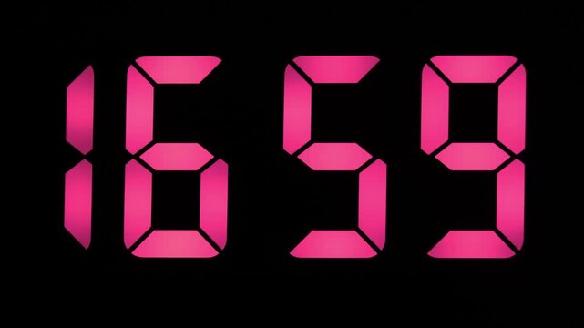 Electronic clock counting down seconds to 17:00, pink or red digits on a digital display.