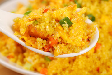 Golden Turmeric Rice Pilaf with Vegetables Close-up on Spoon