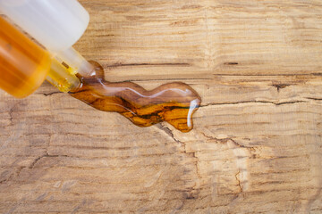 Double syringe with epoxy gel glue spilling on genuine brown leather texture, soft focus close up