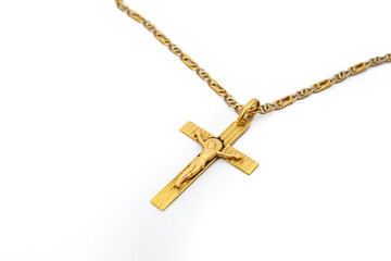 Golden chain necklace with a crucifix, side view close up soft focus isolated on white background
