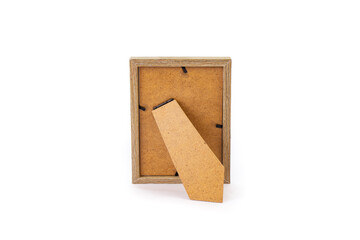 Back of a picture frame with cardboard cover and support with shadows isolated on white background