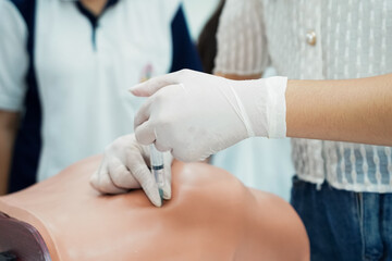 Nursing Student Practicing Injection with Training Model