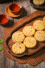 Mixed Grain Rice Cakes with Purple Potato and Nuts on Bamboo Tray - Traditional Asian Snack Food
