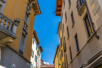 Narrow Italian Muralto street in Como city. Window wall. Multicolor old house building architecture. Medieval village