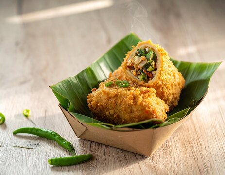 Close-up shot of delicious fried risoles, a savory Indonesian snack, served on a banana leaf.