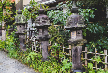 Moss-Covered Traditional Stone Lanterns in Japanese Garden