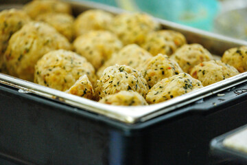 Tasty herb and cheese meatballs in metal tray