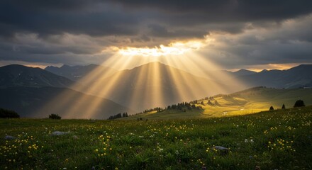 Sunbeams through clouds over misty mountains.