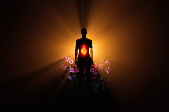 Silhouette of a man walking in a tunnel at night with sunset sky background