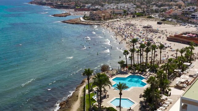 Aerial view of La Zenia Beach, a sandy beach south of the Torrevieja city in the province of Alicante, Spain. Located in an urban setting, with a beautiful promenade.