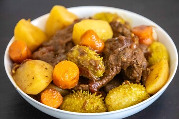 The most authentic and original Brazilian rustic pot roast, carne de panela,  with woody sauce and vegetables, served with farofa and salad