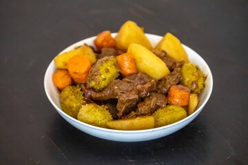 The most authentic and original Brazilian rustic pot roast, carne de panela,  with woody sauce and vegetables, served with farofa and salad