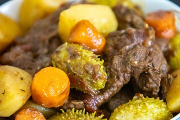 The most authentic and original Brazilian rustic pot roast, carne de panela,  with woody sauce and vegetables, served with farofa and salad