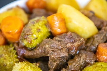 The most authentic and original Brazilian rustic pot roast, carne de panela,  with woody sauce and vegetables, served with farofa and salad
