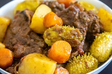 The most authentic and original Brazilian rustic pot roast, carne de panela,  with woody sauce and vegetables, served with farofa and salad