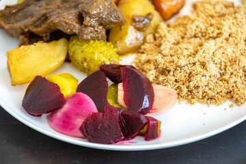 The most authentic and original Brazilian rustic pot roast, carne de panela,  with woody sauce and vegetables, served with farofa and salad