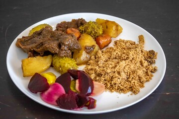 The most authentic and original Brazilian rustic pot roast, carne de panela,  with woody sauce and vegetables, served with farofa and salad