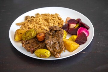 The most authentic and original Brazilian rustic pot roast, carne de panela,  with woody sauce and vegetables, served with farofa and salad