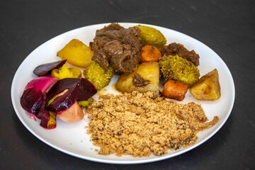 The most authentic and original Brazilian rustic pot roast, carne de panela,  with woody sauce and vegetables, served with farofa and salad
