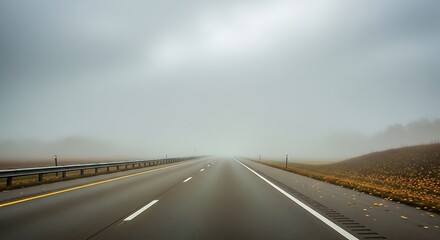 Long highway stretching into dense fog on a cloudy day.