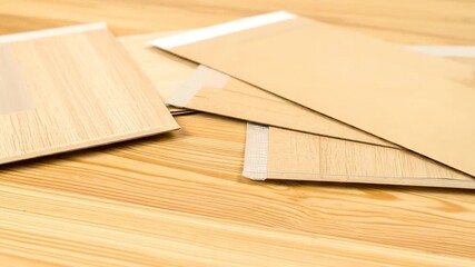 Light beige envelopes on a light wooden surface - Powered by Adobe