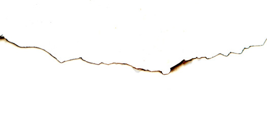 Black-brown burn marks on the edge of white paper