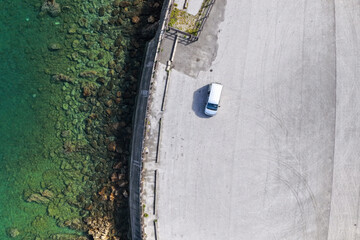 Top-Down Aerial View of Car Driving on Coastal Road in Ōgimi Village (大宜味村), Okinawa, Japan