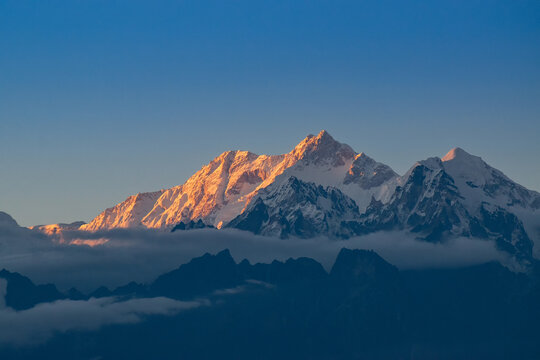 Beautiful last light from sunset on Mount Kanchenjugha, Himalayan mountain range, Sikkim, India. color tint on the mountains at dusk