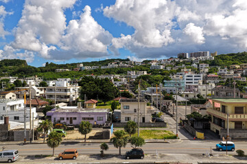 Obraz premium Residential Area in Nagahama, Yomitan Village, Okinawa, Japan with Blue Sky and Clouds