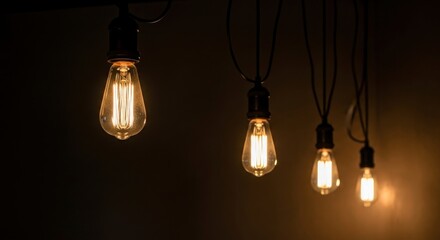 Warm glow of vintage Edison light bulbs against a dark background, creating a cozy atmosphere.