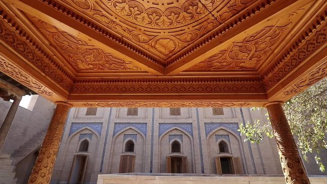 Khiva, Uzbekistan, Pahlavan Mahmud Mausoleum courtyard, magnificent decorations of columns and carved wooden ceiling, UNESCO World Heritage Site